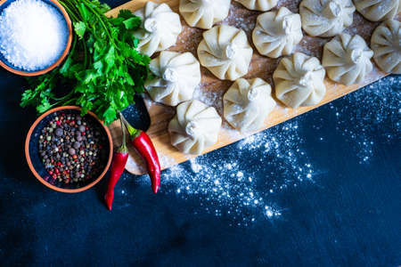 Famous georgian dish meat khinkali uncooked on cutting board with copy spaceの写真素材