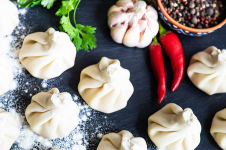 Famous georgian dish meat khinkali uncooked on cutting board with copy spaceの写真素材