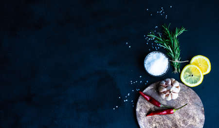 Herbs and spices on dark wooden background as a cooking ingredients concept with copy spaceの写真素材