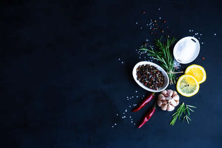 Herbs and spices on dark wooden background as a cooking ingredients concept with copy spaceの写真素材