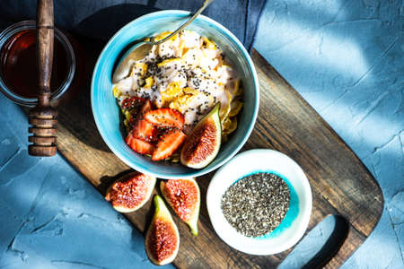 Traditional healthy breakfast with fresh organic strawberry and figs, chia seeds, yogurt and honeyの写真素材