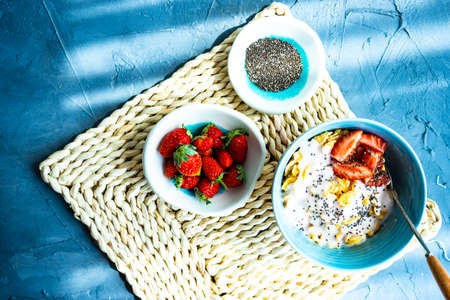 Traditional healthy breakfast with fresh organic strawberry and figs, chia seeds, yogurt and honey