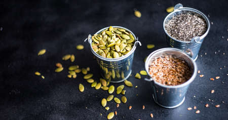 Bowl of various superfoods on white wooden background with copy space