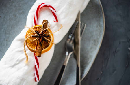Rustic table setting for festive Christmas dinner on concrete table with decoration