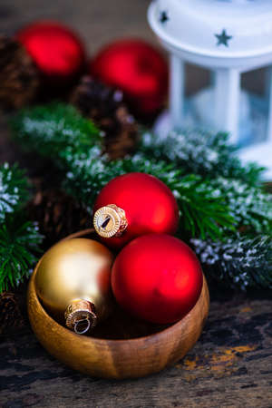 Christmas crd concept with christmas balls and christmas tree on dark wooden backgroundの写真素材