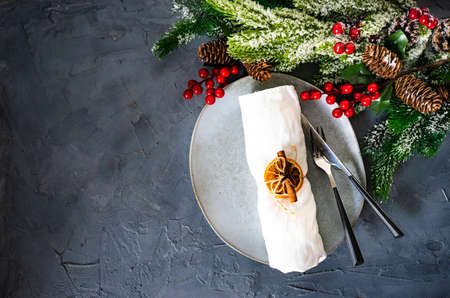 Rustic table setting for festive Christmas dinner on concrete table with decoration
