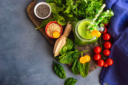 Green smoothie of apple, baby spinacj, cucumber, chia seeds on concrete background with copy spaceの写真素材