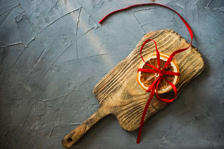 Christmas food concept with drienf oranges on blackboard with copy spaceの写真素材