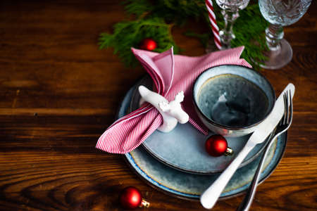 Festive table setting for Christmas dinner on vintage wooden table with copy spaceの写真素材