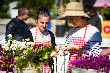 TBILISI, GEORGIA, 2018, October 06: Beautiful georgian girls are preparing flower composition on the celebration of city day in georgian capital, Tbilisi, Republic of Georgiaのeditorial素材