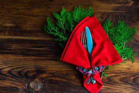 Festive table setting for Christmas dinner on vintage wooden table with copy spaceの写真素材