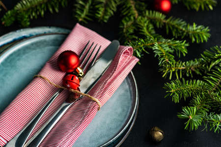 Festive table setting with ceramic plate and holiday decor on wooden background with copy spaceの写真素材