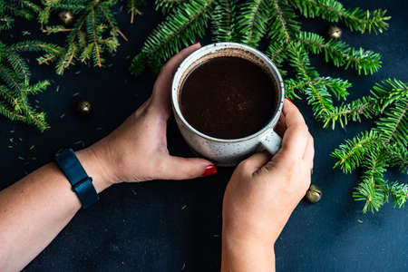 Cup of coffee on dark wooden background with holiday decor and copy spaceの写真素材