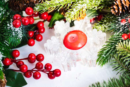 Christmas card concept with christmas tree, berries and festive decor on white background