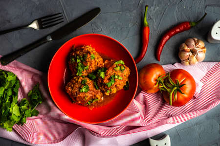 Meatballs in spicy tomato sauce with coriander and garlic on rustic tableの写真素材