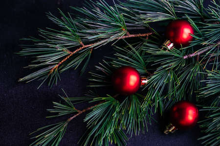 Festive Christmas frame with balls and fir tree on dark wooden background with copy spaceの写真素材