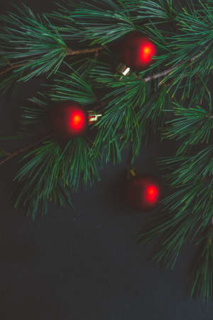 Festive Christmas frame with balls and fir tree on dark wooden background with copy spaceの写真素材