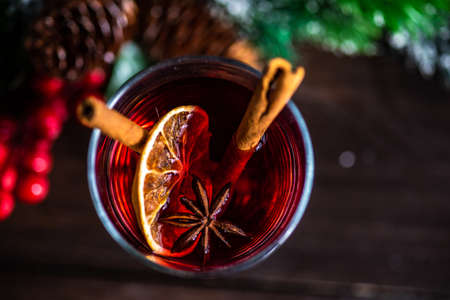 Mulled wine with cinnamon and anise star spices in a glass as a christmas holiday conceptの写真素材