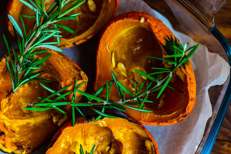 Baked pumpkin slice with rosemary on plate with copy spaceの写真素材