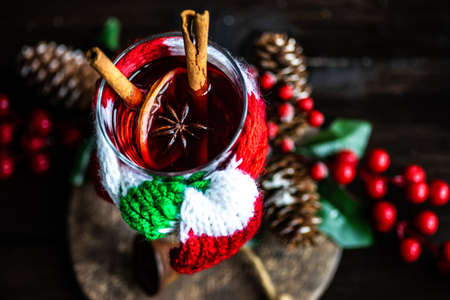 Mulled wine with cinnamon and anise star spices in a glass as a christmas holiday conceptの写真素材