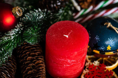 Christmas frame with fir tree,  berries, cones and decor on dark background