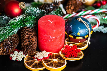 Christmas frame with fir tree,  berries, cones and decor on dark backgroundの写真素材