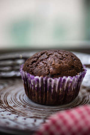 Tasty lemon and chocolate cupcakes in rustic interiorの写真素材