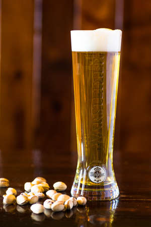 TBILISI, GEORGIA - FEB 02, 2018: Glass of Warsteiner Premium Verum, the most popular beer of Warsteiner, Germany's largest privately owned brewery, operating since 1753, in the pub in Tbilisi, Georgiaのeditorial素材