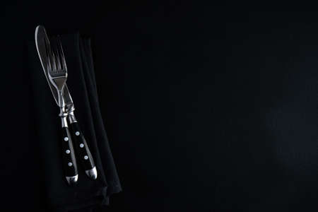 Empty plate, napkin and cutlery on rustic background with copy spaceの写真素材