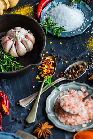 Cooking concept with different spices on dark background with copy spaceの写真素材