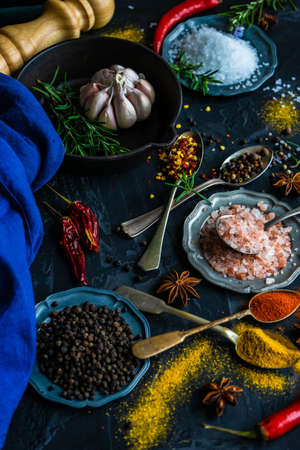 Cooking concept with different spices on dark background with copy spaceの写真素材