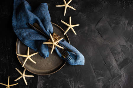 Summer table setting with white sea stars on concrete background with copy spaceの写真素材