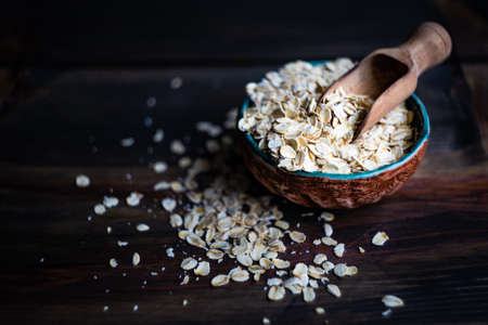 Healthy food concept with oats meal on dark rustic background with copyspaceの写真素材