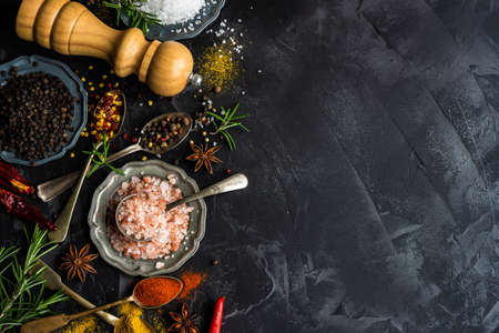 Cooking concept with different spices on dark background with copy spaceの写真素材