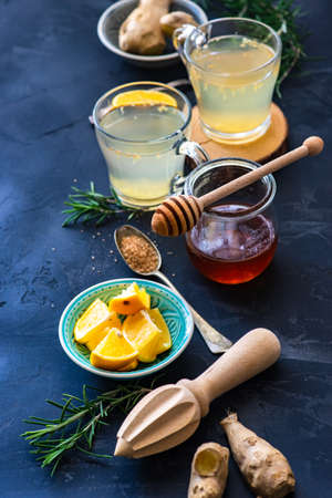Detox drink with ginger and lemon on rustic background with copy space