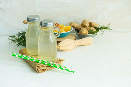 Detox drink with ginger and lemon on rustic background with copy space