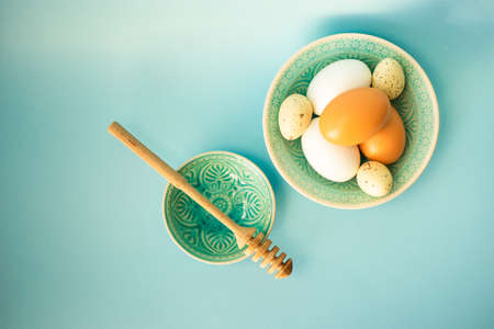 Easter cooking concept with bowl full of eggs on blue background