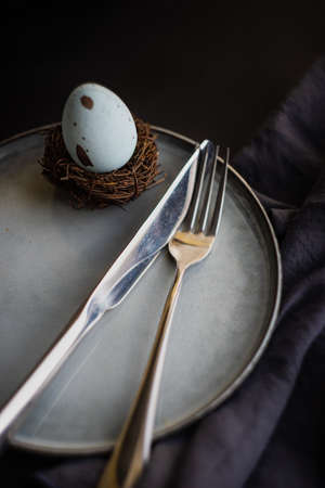 Table setting for festive Easter dinner on rustic background with copy spaceの写真素材