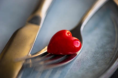 Table setting for dinner in St. Valenites day on grey concrete background with copy space