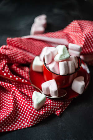 St, Valentines concept with red vintage cup full of heart shaped marshmallow on rustic backgroundの写真素材