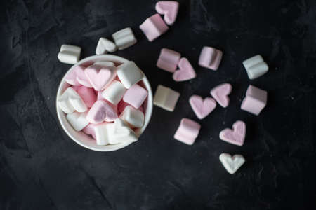 St, Valentines concept with vintage cup full of heart shaped marshmallow on rustic background