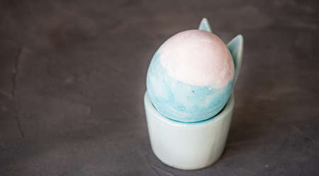 Easter concept with painted boiled eggs for breakfast on concrete background