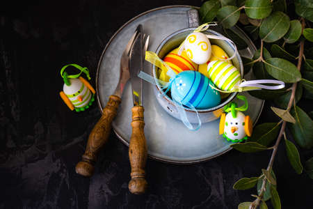 Table setting for festive Easter dinner on rustic background with copy spaceの写真素材