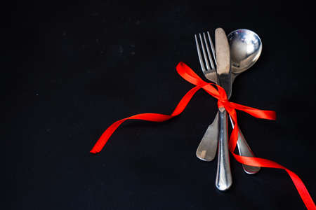 Table setting for St. Valentines day dinner on blackboardの写真素材