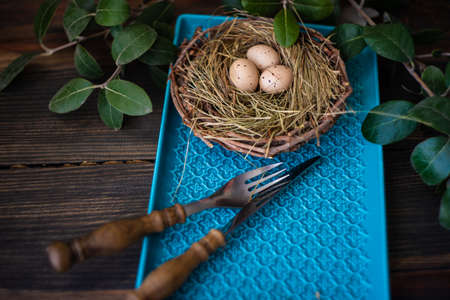 Table setting for festive Easter dinner on rustic background with copy space