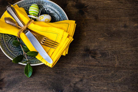 Table setting for festive Easter dinner on rustic background with copy spaceの写真素材