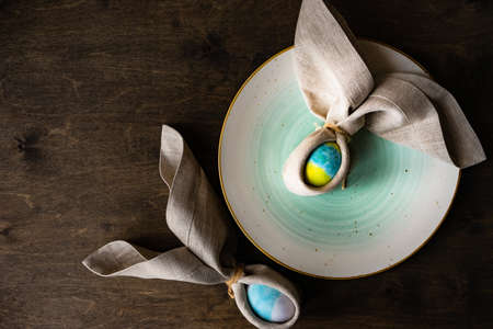 Table setting for festive Easter dinner on rustic background with copy spaceの写真素材