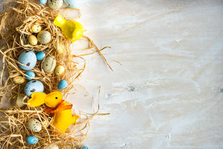 Easter holiday card with variety of easter eggs on white rustic background with copy space