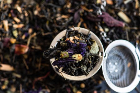 Floral tea in a ceramic bowl on rustic background with copy space