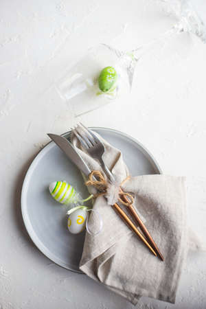 Festive table setting for Easter dinner on white background with copy spaceの写真素材